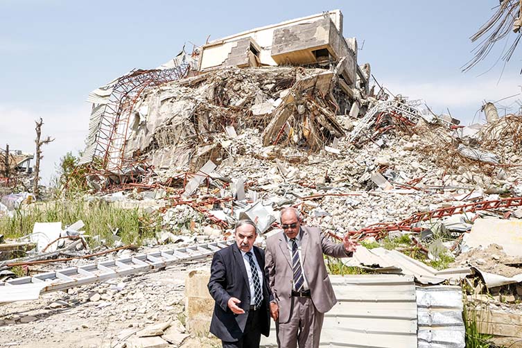 Administrators survey the ruins of Mosul University in East Mosul