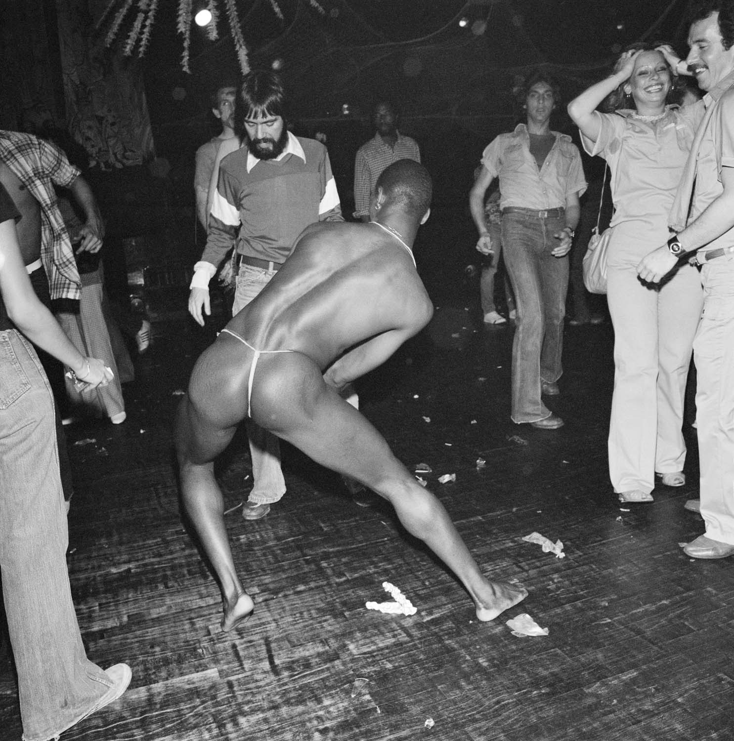 Bent over dancer wearing white string. Paradise Garage, New York,  1978