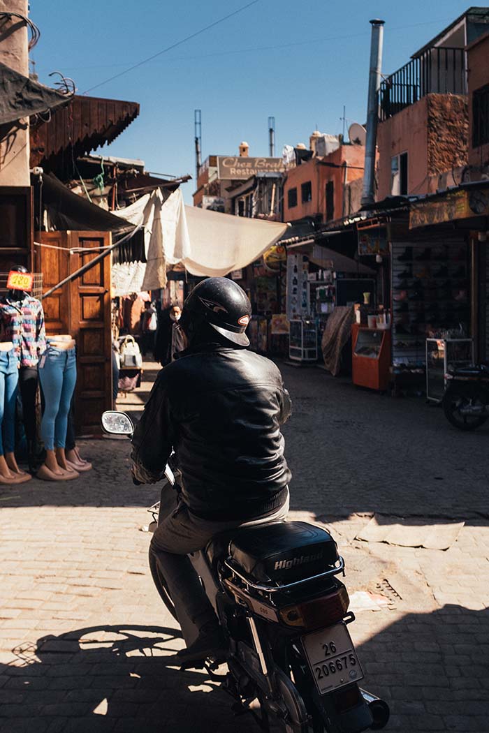 Motorbikes weave their way through the chaotic streets of the Marrakech Medina