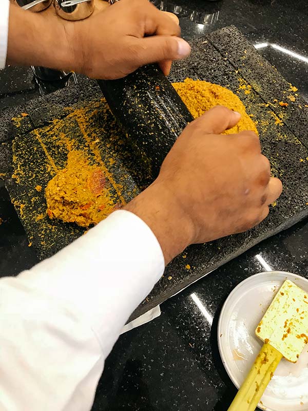 Crafting a typical Mauritian free range chicken curry under the tutelage of executive chef Khader Rehad