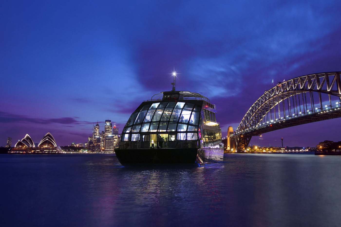 The Clearview Glass Boat cruising on Sydney Harbour with the Harbour Bridge and Opera House in the background