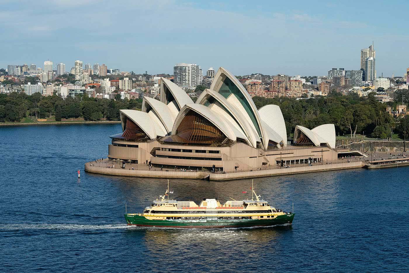 A ferry in Sydney gliding past the Opera House