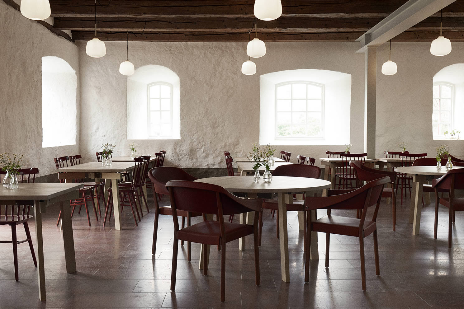 Wanås Restaurant with table from Blå station and chairs from Gärsnäs covered in leather from the Wanås Estate.