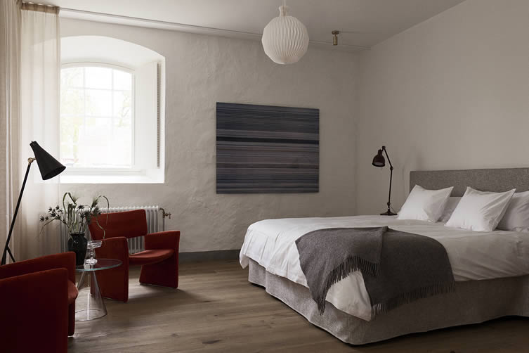 Hotel room at Wanås Hotel featuring flooring made from oak from the estate, lights by RUBN and art by Niko Luoma, Collectors Item (stolen from newsstands, 1992 – 2004), 2004.