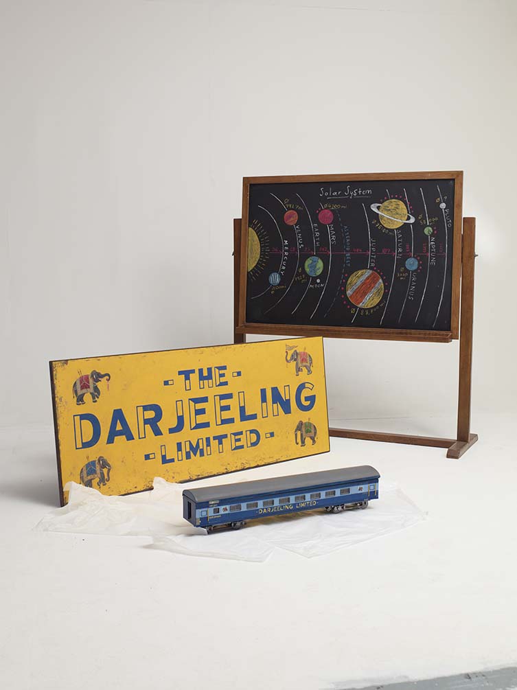 Miniature model and sign of the train, THE DARJEELING LIMITED, and blackboard depicting the Solar System, ASTEROID CITY. Photo Richard Round-Turner. © the Design Museum